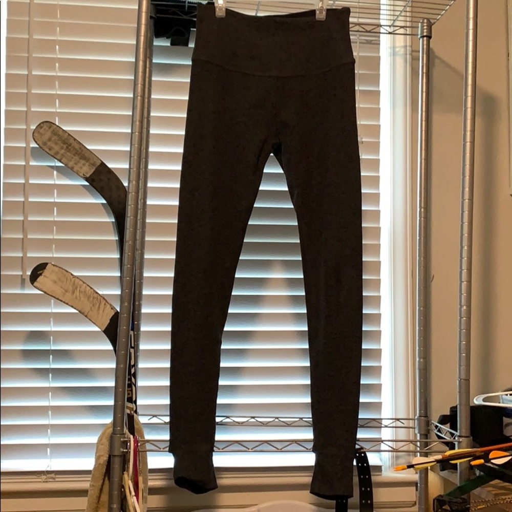 Dark grey Beyond Yoga leggings with foot cutout